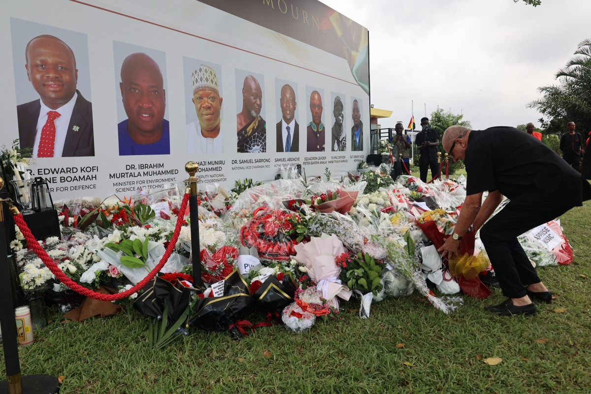 A man lays flowers and pays tribute to the victims of a military helicopter crash in Accra, Ghana, on Aug. 9, 2025. (Photo by Seth/Xinhua)
