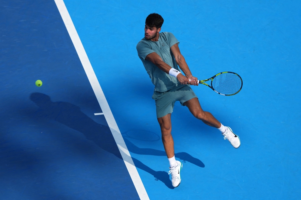 Carlos Alcaraz of Spain plays a backhand during the match against Andrey Rublev during Day 9 of the Cincinnati Open at the Lindner Family Tennis Center on August 15, 2025 in Mason, Ohio. Dylan Buell/Getty Images/AFP