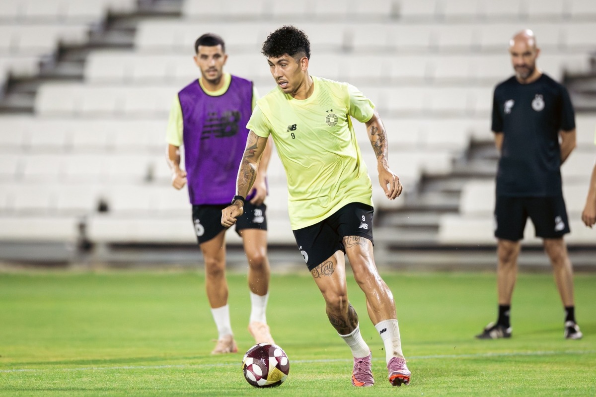 Al Sadd’s Roberto Firmino (centre) in action during training as coach Felix Sanchez (right) watches on.
