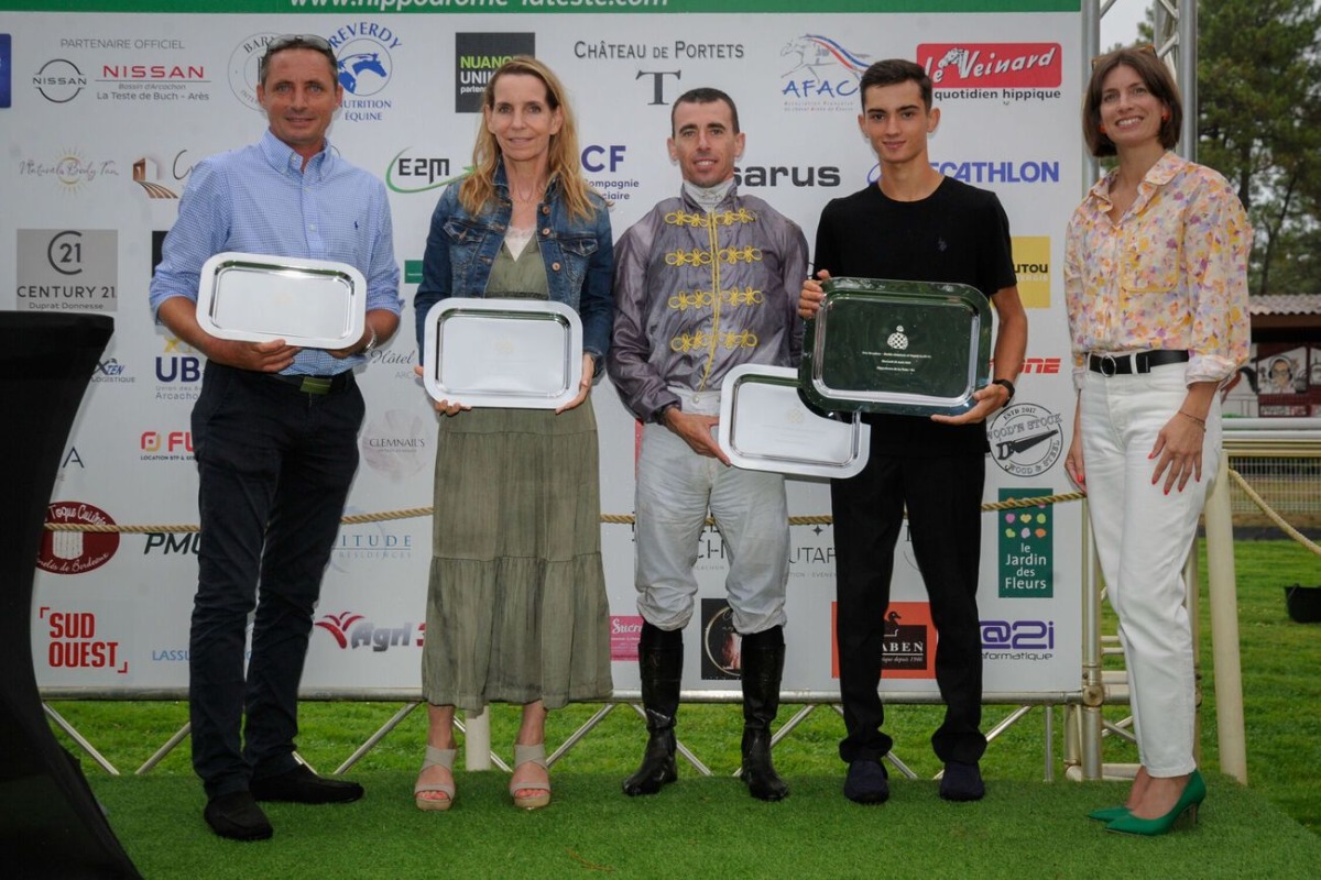 The connections of Hajmah pose with their trophies. 
