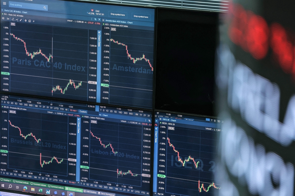 (Files) Market indicators are displayed on digital screen at the Euronext trading exchange building in La Defense business district, west of Paris, on April 7, 2025. (Photo by Thomas Samson / AFP)