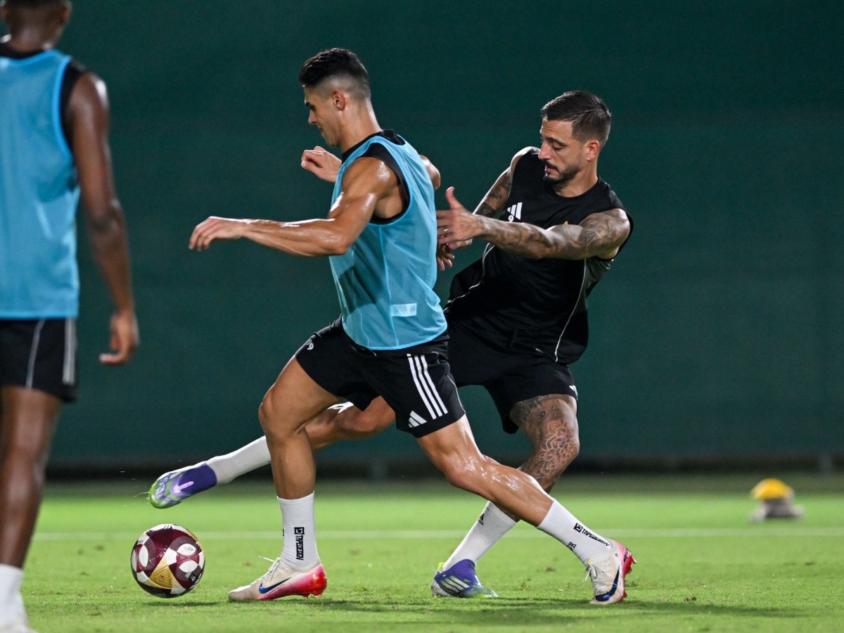 Al Gharafa's Joselu (right) in action with a teammate during a training session.