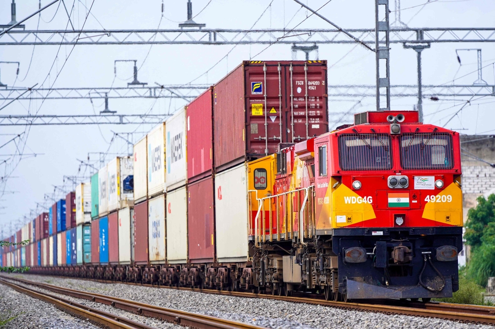 A freight train carrying cargo containers rides along a railway track in Ajmer on August 26, 2025. Photo by Himanshu Sharma / AFP