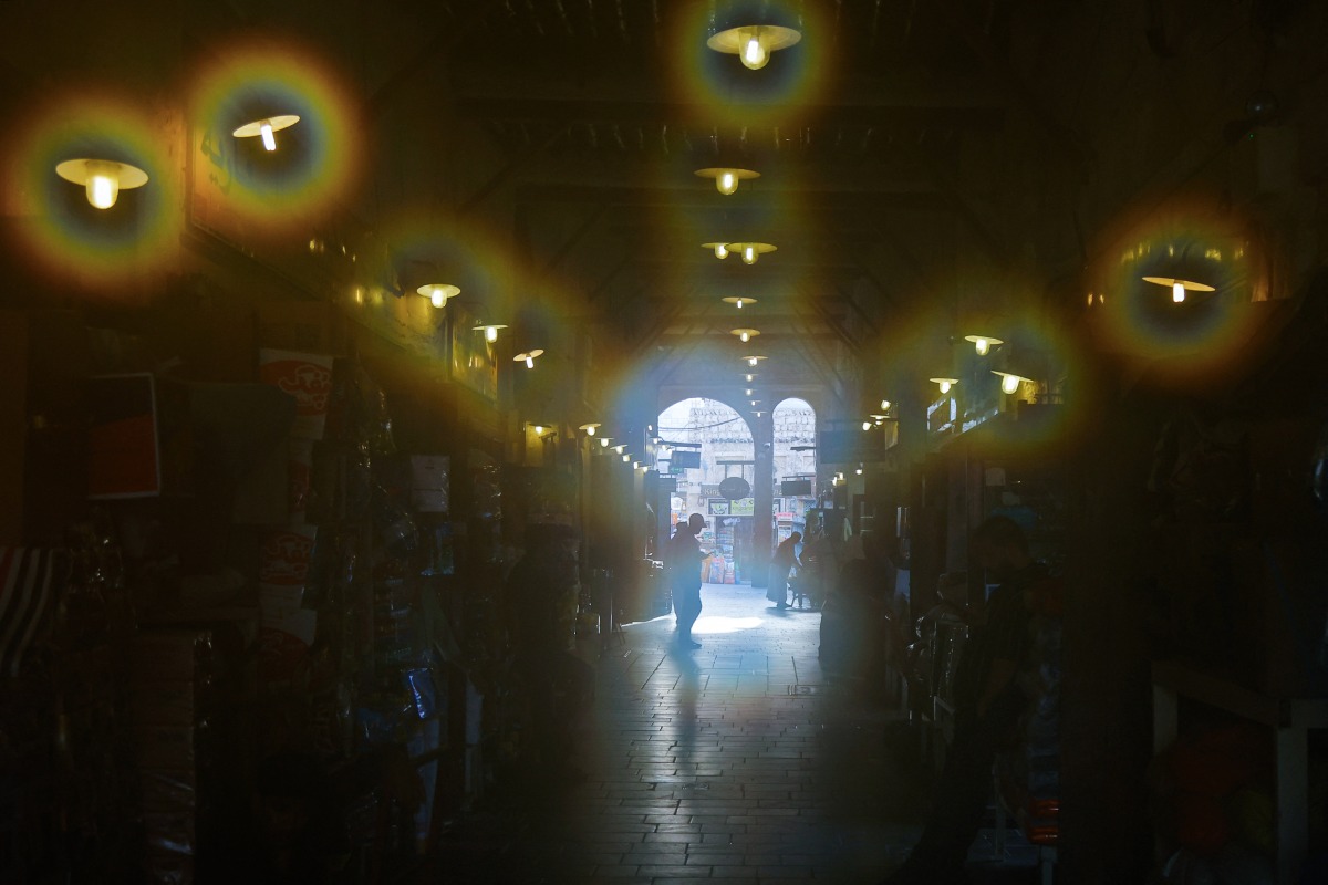 People visit the Souq Waqif bazaar on a humid and hot day in Doha on July 24, 2025. (Photo by Karim Jaafar/ AFP)