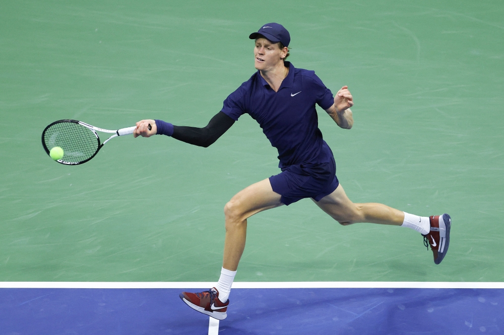 Jannik Sinner of Italy returns a shot against Lorenzo Musetti of Italy during their Men's Quarterfinal match on Day Eleven of the 2025 US Open. Matthew Stockman/Getty Images/AFP 
 