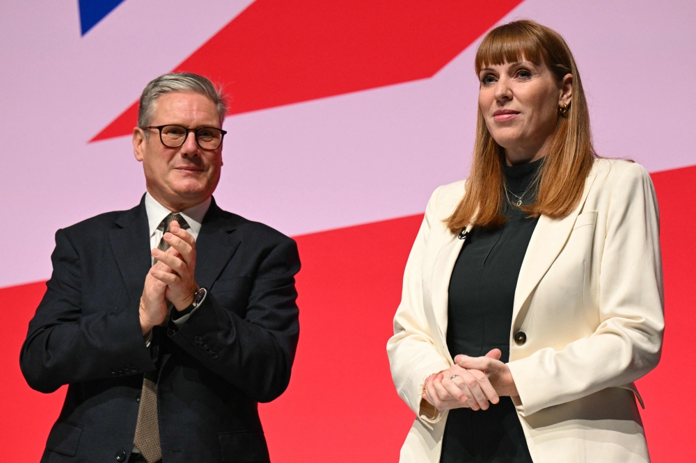 File: Britain's Prime Minister Keir Starmer (left) applauds Deputy Prime Minister, and Secretary of State for Housing, Communities and Local Government Angela Rayner on stage on the first full day of the annual Labour Party conference in Liverpool, north-west England, on September 22, 2024. (Photo by Oli Scarff / AFP)
