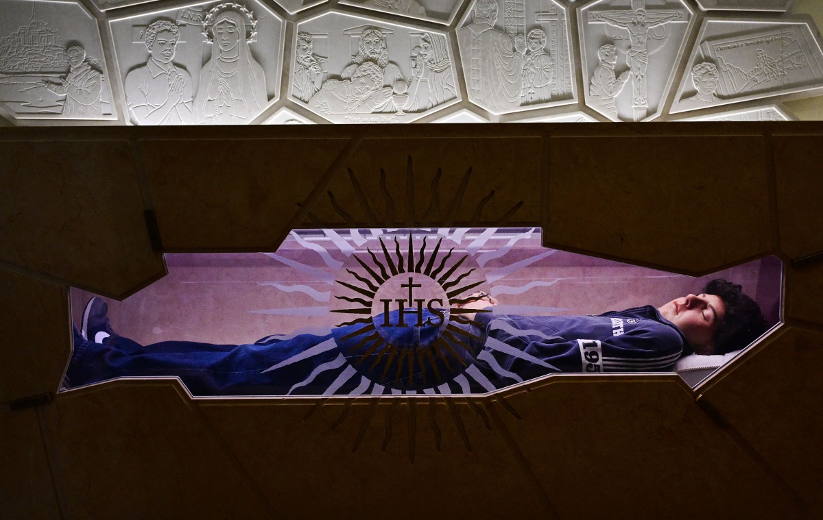 A picture shows the tomb of Blessed Carlo Acutis, an adolescent who spent his life spreading his faith online, earning the moniker