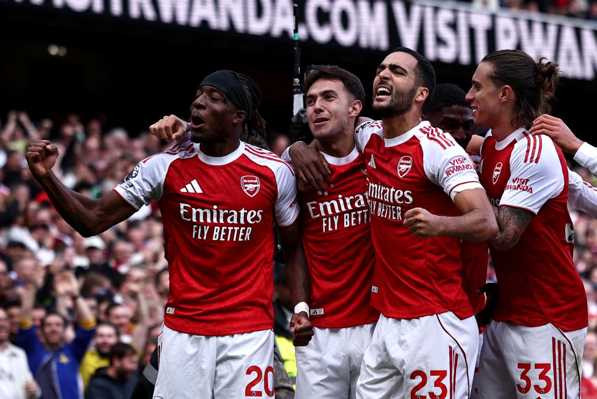Arsenal's Spanish defender #36 Martin Zubimendi (2L) celebrates scoring the team's first goal with Arsenal's English defender #20 Noni Madueke (L) during the English Premier League football match between Arsenal and Nottingham Forest at the Emirates Stadium in London on September 13, 2025. (Photo by HENRY NICHOLLS / AFP)