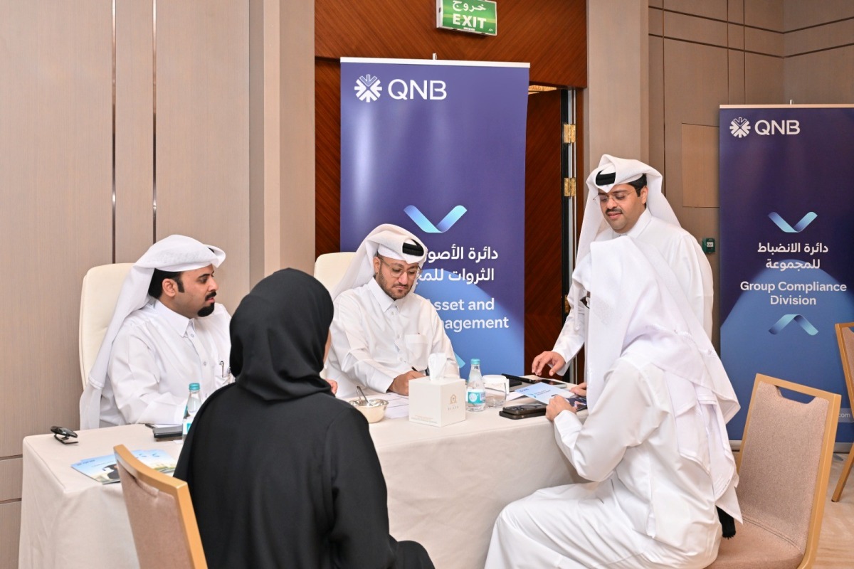 Officials and Qatari graduates during the event. 