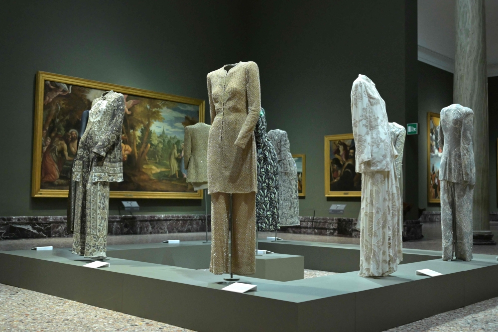 A picture shows creations by Italian designer Giorgio Armani during the press preview of the Giorgio Armani exhibition marking the 50th anniversary of the fashion house, at the Pinacoteca di Brera Museum in Milan on September 23, 2025. (Photo by Stefano Rellandini / AFP) 