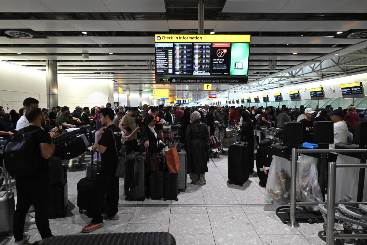 Travellers wait in terminal 4 at Heathrow Airport, west of London on September 20, 2025. Photo by JUSTIN TALLIS / AFP

