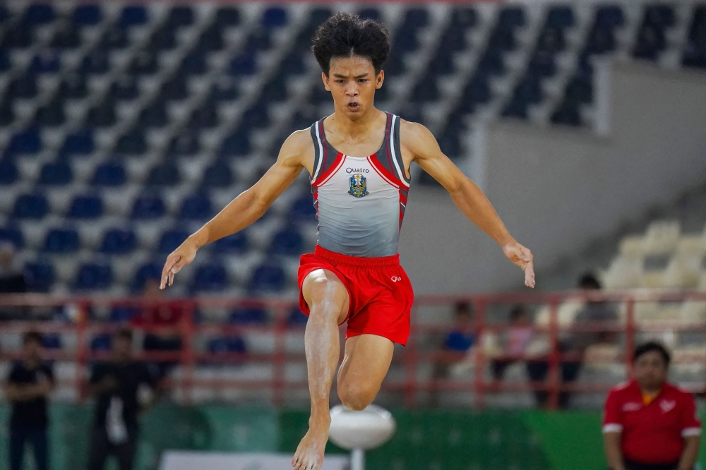 This picture taken on August 30, 2024 shows Indonesian gymnast Naufal Takdir Al Bari representing East Java competing at the 21st National Sports Week in Deli Serdang, North Sumatra. (Photo by Hendra Syamhari / AFP)