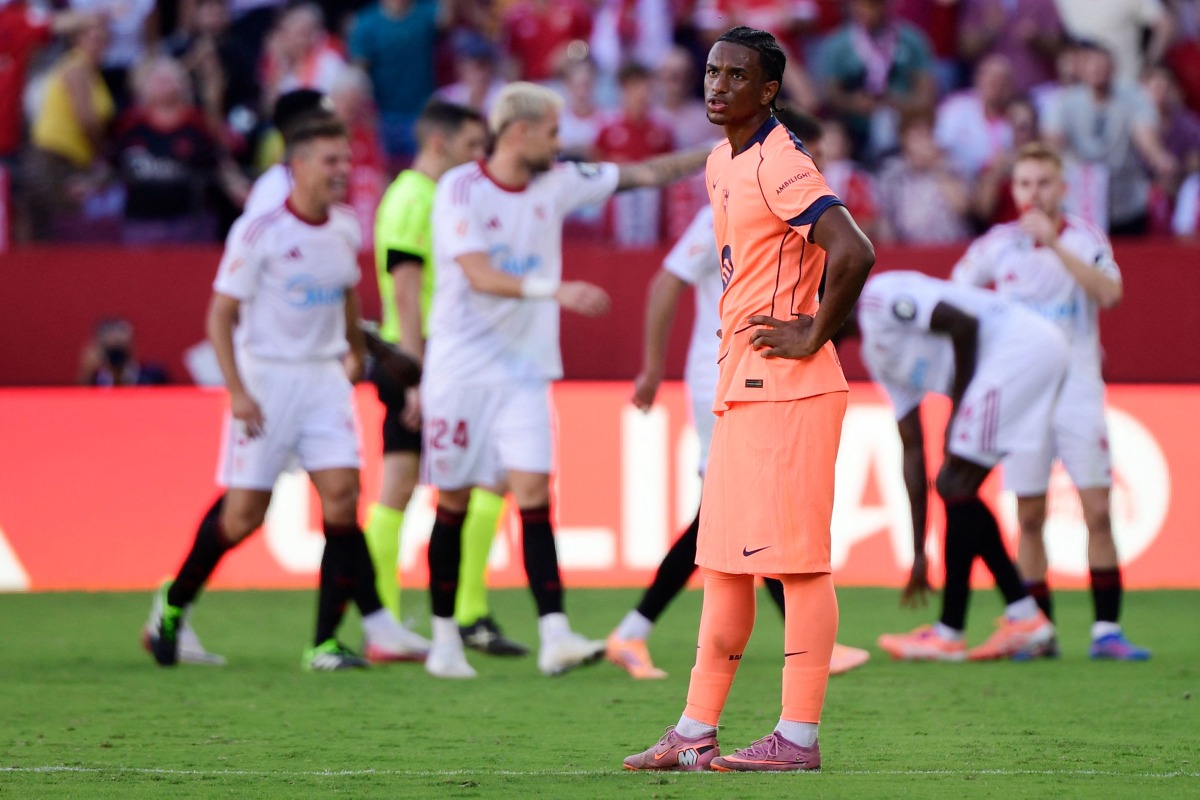 Barcelona's Spanish defender #03 Alex Balde reacts to Sevilla's third goal scored by Spanish defender #02 Jose Angel Carmona during the Spanish league football match between Sevilla FC and FC Barcelona at Ramon Sanchez Pizjuan Stadium in Seville on October 5, 2025. (Photo by CRISTINA QUICLER / AFP)
