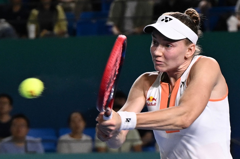 Kazakhstan's Elena Rybakina hits a return to Italy's Jasmine Paolini on October 18, 2025. (Photo by AFP)