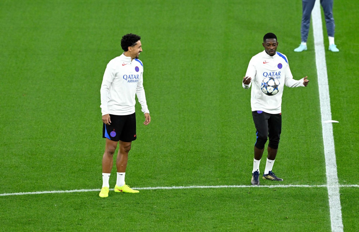 Paris Saint-Germain’s Ousmane Dembele (right) and Marquinhos attend a training session