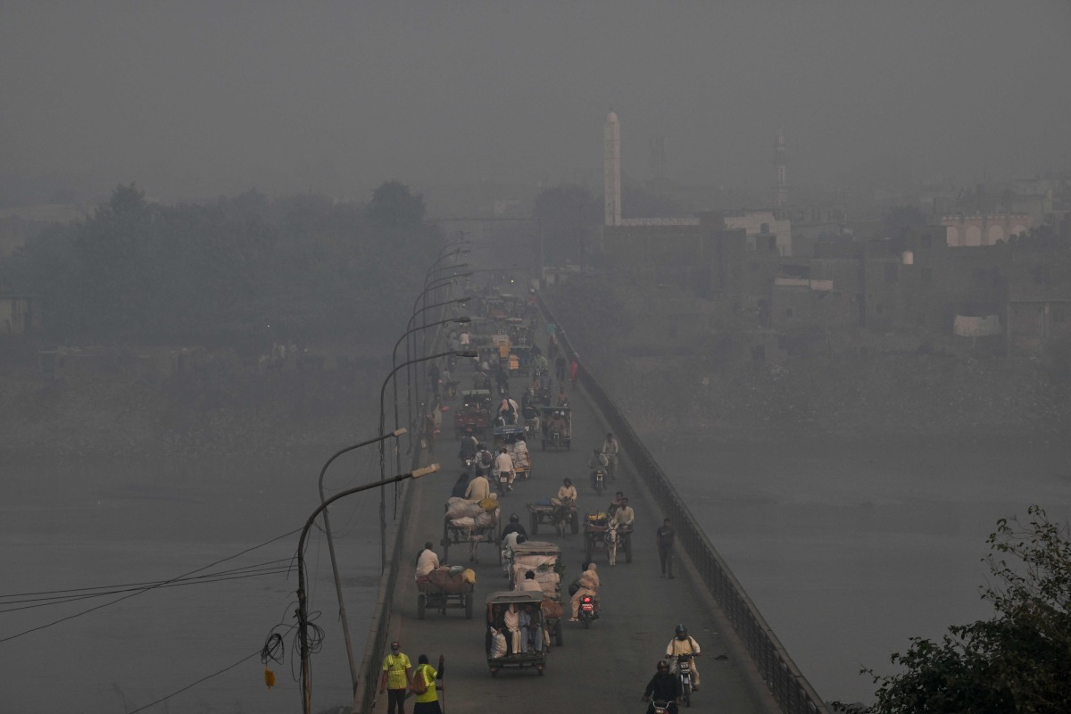 Commuters drive across a bridge amid dense smog in Lahore on October 27, 2025. (Photo by Arif ALI / AFP). Photo used for representational purposes only.