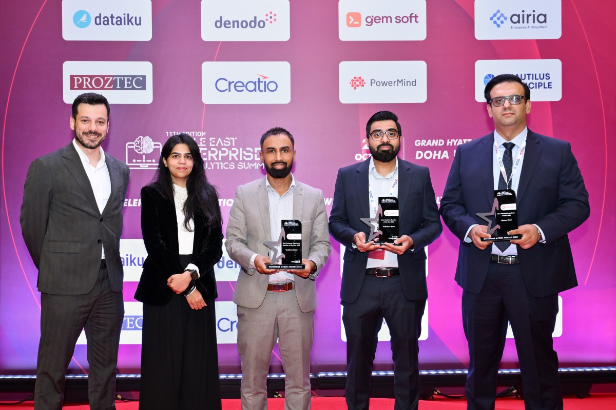 Officials pose for a group photo with the awards.