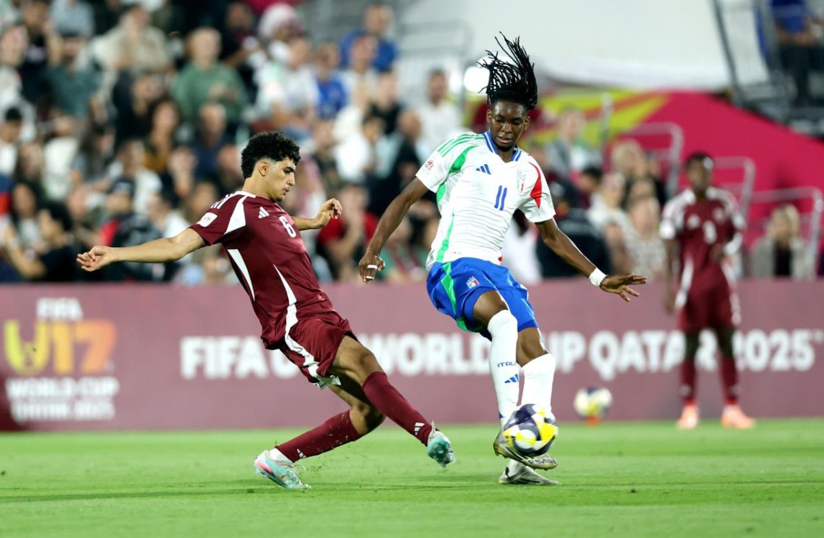 Qatar's Adam Friakh (left) and Italy's Destiny Elimoghale vie for the ball possession. 