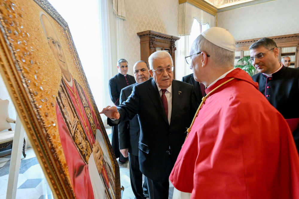This photo taken and handout on November 6, 2025 by The Vatican Media shows Pope Leo XIV during a meeting with Palestinian President Mahmud Abbas in The Vatican. (Photo by Handout  / AFP) 