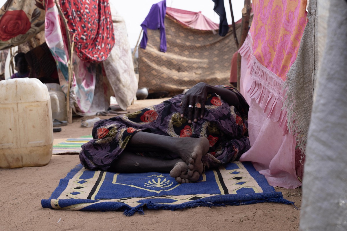 A displaced Sudanese who fled El-Fasher after the city fell to the Rapid Support Forces (RSF), rest on a mat in the camp of Um Yanqur, located on the southwestern edge of Tawila, in war-torn Sudan's western Darfur region on November 3, 2025. (Photo by AFP)

