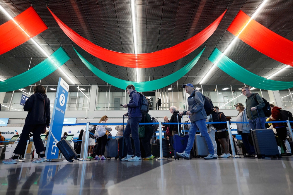 Travelers wait in line at a security checkpoint at O'Hare International Airport in Chicago, Illinois on November 7 2025. (Photo by Kamil Krzaczynski / AFP)