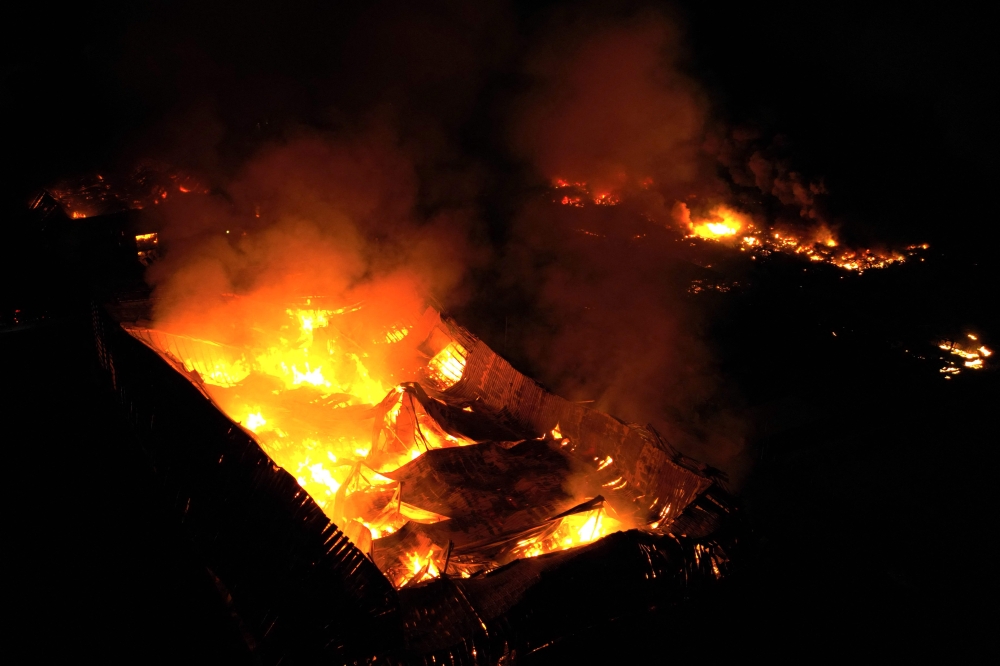 This aerial view shows a fire after an explosion in an industrial area of Ezeiza, Buenos Aires province, Argentina on November 14, 2025. (Photo by Luis Robayo / AFP)