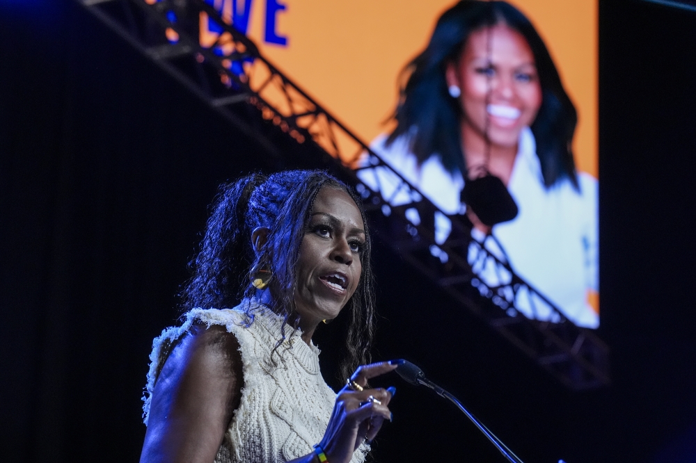 Former first lady Michelle Obama addresses the crowd at the When We All Vote Rally outside Atlanta, a campaign appearance stumping for Vice President Kamala Harris last year. Jahi Chikwendiu/The Washington Post