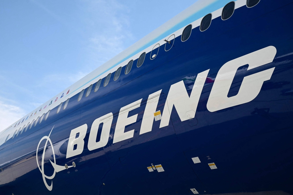 A Boeing 777-9 sits on the tarmac at Al-Maktoum International Airport during the Dubai Airshow 2025 in Dubai on November 17, 2025. (Photo by Giuseppe Cacace / AFP)