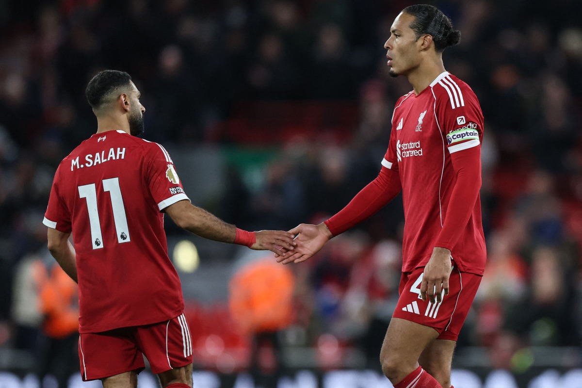Liverpool's Dutch defender Virgil Van Dijk and Liverpool's Egyptian striker Mohamed Salah react at the end of their loss during the English Premier League football match between Liverpool and Nottingham Forest at Anfield in Liverpool, north west England on November 22, 2025. (Photo by Darren Staples / AFP)