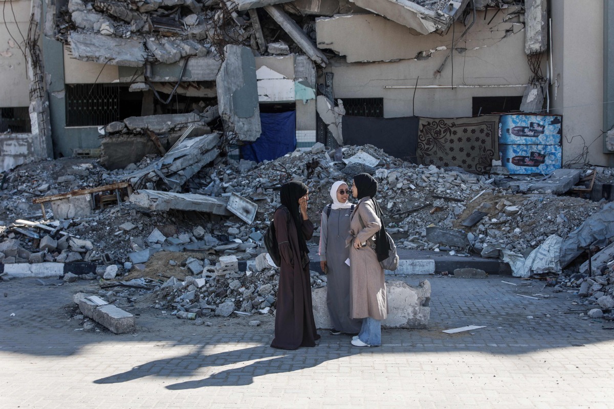Students interact at the Islamic University after the resumption of classes during a ceasefire between Israel and Hamas in Gaza City, on December 2, 2025. (Photo by Omar AL-QATTAA / AFP)