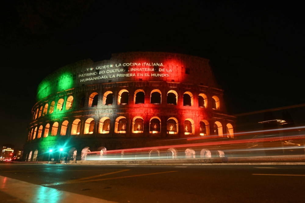 The Colosseum is illuminated and a message reads 
