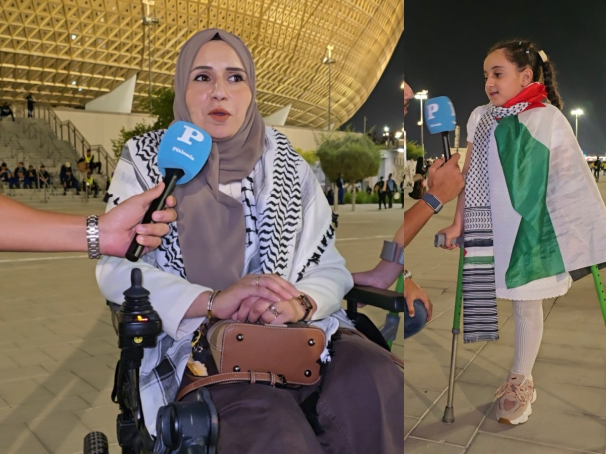 A Palestinian woman and child injured during the Gaza war speak during the Palestine-Saudi Arabia match of the FIFA Arab Cup Qatar at Lusail Stadium on Thursday. 