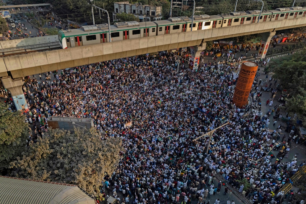 An aerial view shows protesters at Shahbagh intersection in Dhaka on December 19, 2025, following the death of youth leader Sharif Osman Hadi. (Photo by Abdul Goni / AFP)