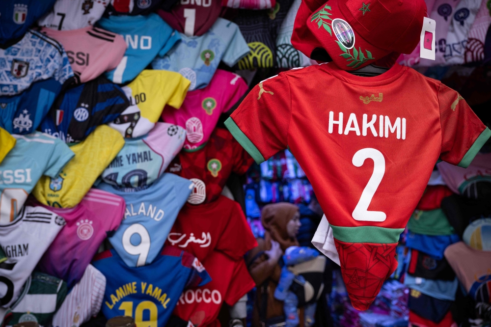 Morocco defender Achraf Hakimi's jersey is displayed in a shop in Rabat, on December 19, 2025, ahead of the Africa Cup of Nations (AFCON). (Photo by Sebastien Bozon / AFP)