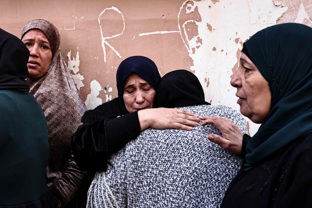 Women grieve during the funeral of Ahmad Zyoud in the village of Silat al-Harithiya, close to the northern West Bank city of Jenin on December 21, 2025. (Photo by Zain JAAFAR / AFP)
