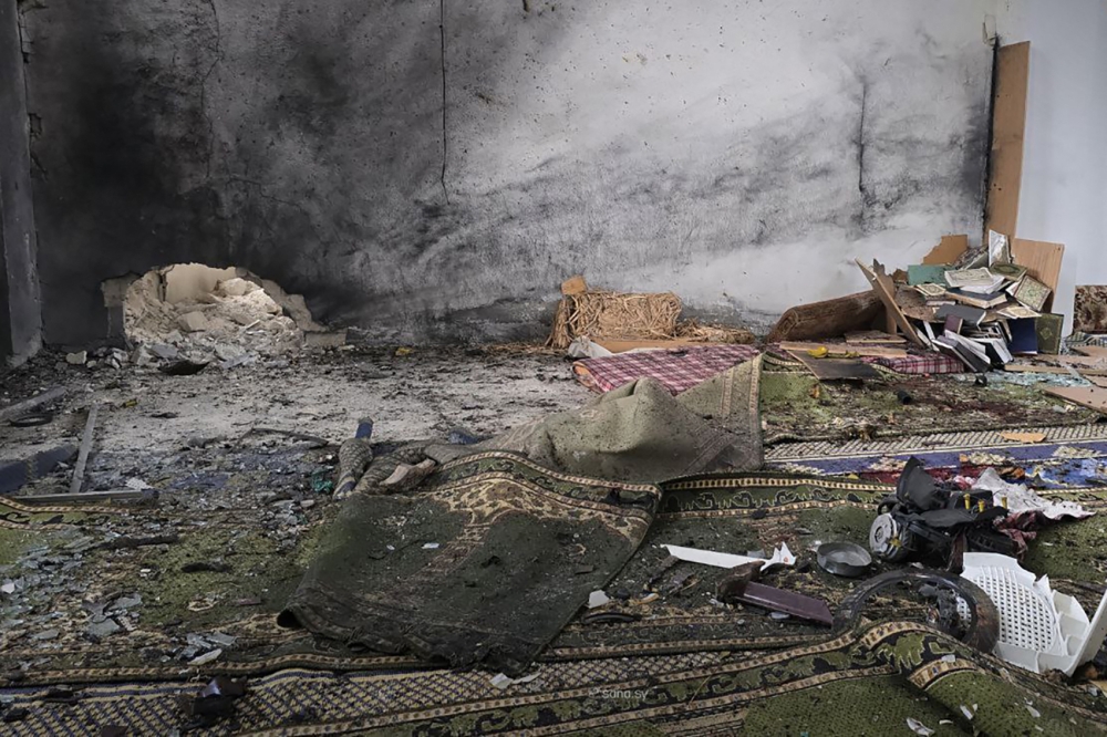 This handout photograph released by the official Syrian Arab News Agency (SANA) on December 26, 2025, shows the aftermath of the explosion inside Imam Ali ibn Abi Talib Mosque in the Wadi al-Dahab neighborhood of Homs. A deadly explosion hit a mosque in a predominantly Alawite area of Syria's Homs on December 26, said authorities who reported at least six people killed. (Photo by HANDOUT / SANA / AFP