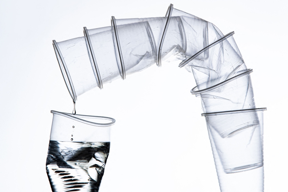 An illustration photograph taken in Paris, on July 31, 2019 shows disposable plastics cups.  (Photo by Joel Saget / AFP)