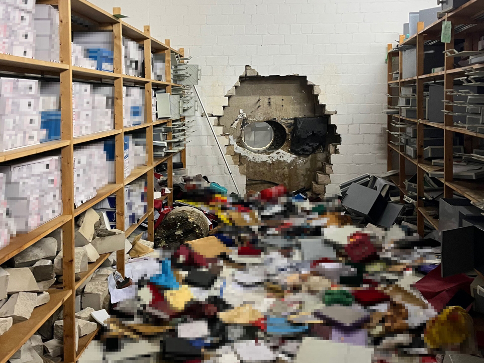 This handout photo taken on December 29, 2025 in Gelsenkirchen, Wwestern Germany, and handed out by the Police Gelsenkirchen shows a giant hole in a wall of the bank vault of a Sparkasse bank branch after the unknown perpetrator(s) broke in during the Christmas holidays. According to media reports from December 30, 2025, concerned bank customers gathered in front of the bank to find out what happened to their valuables. (Photo by Handout / Police Gelsenkirchen / AFP)
