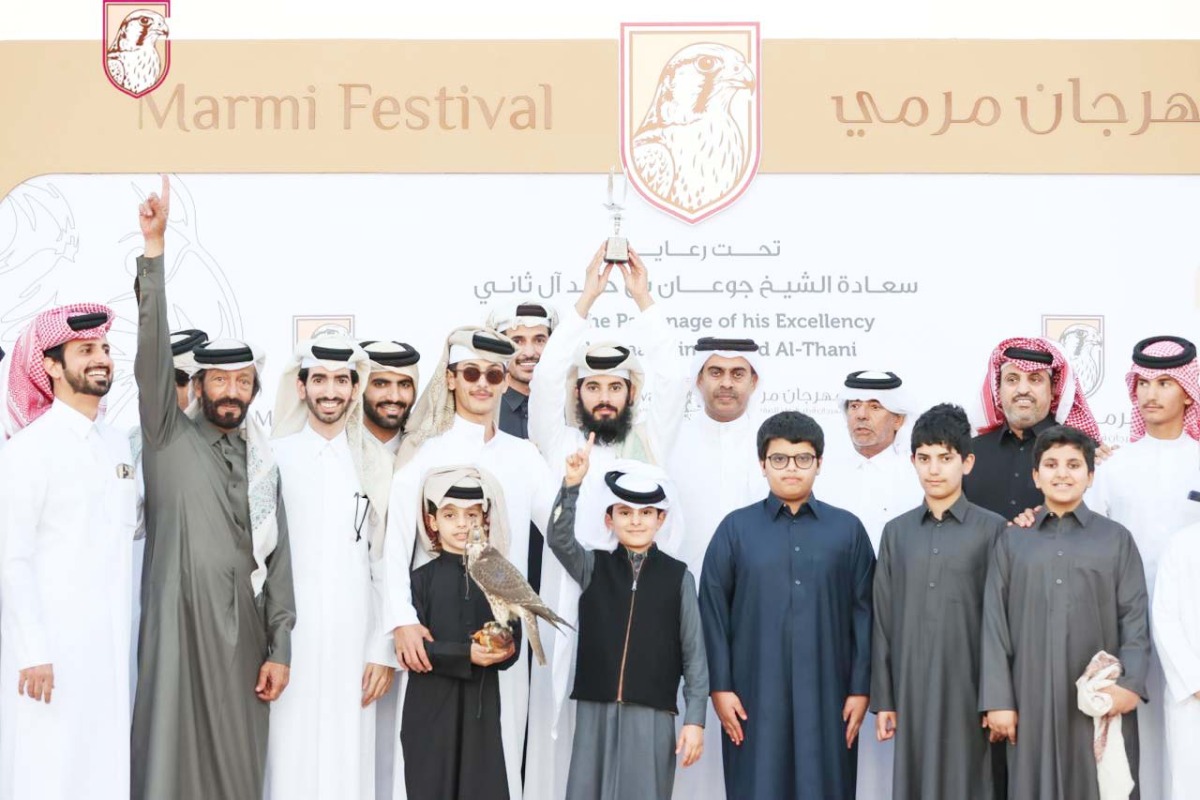 Falconers and participants after winning a competition on the first day of the festival.   