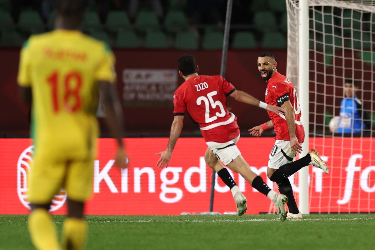 Egypt's forward #10 Mohamed Salah (R) celebrates scoring his team's third goal during the Africa Cup of Nations (CAN) round of 16 football match between Egypt and Benin at the Grand Stadium in Agadir on January 5, 2026. (Photo by FRANCK FIFE / AFP)
