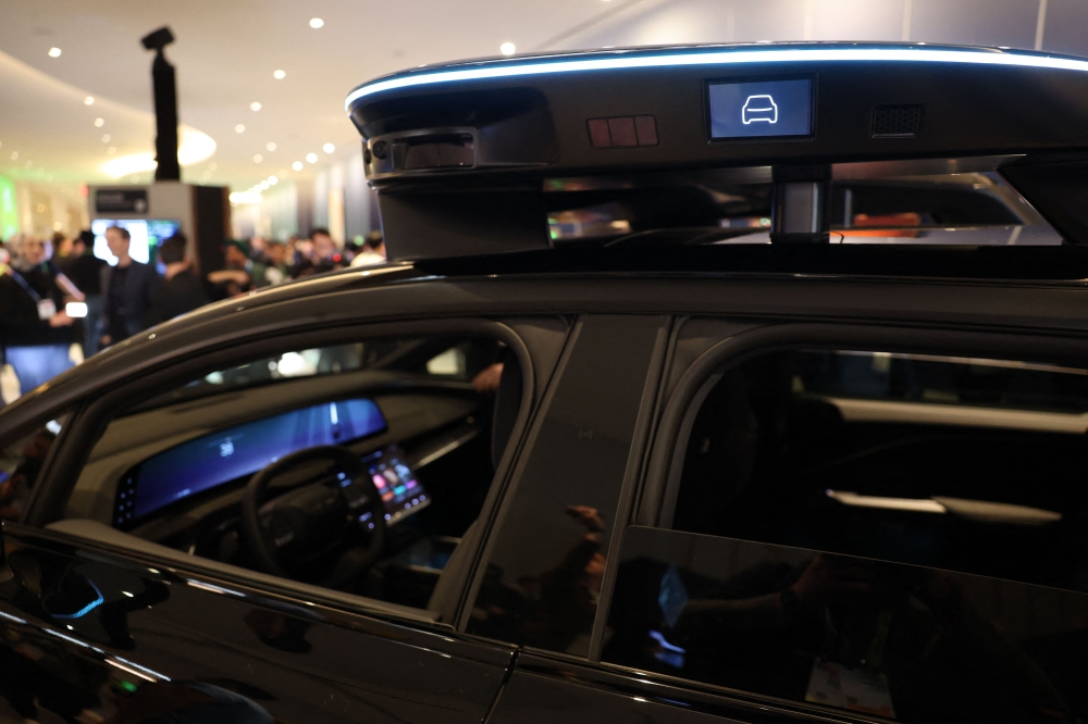 Lucid, Nuro, and Uber unveil a robotaxi during Nvidia Live at CES 2026 ahead of the annual Consumer Electronics Show in Las Vegas, Nevada, on January 5, 2026. (Photo by Patrick T. Fallon / AFP)