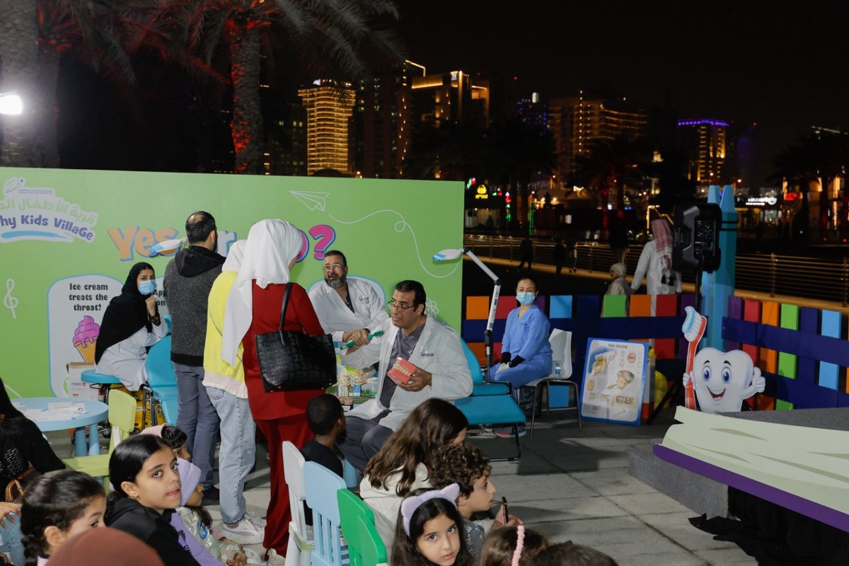 Doctors interacting with parents during the Kids Healthy Village event.