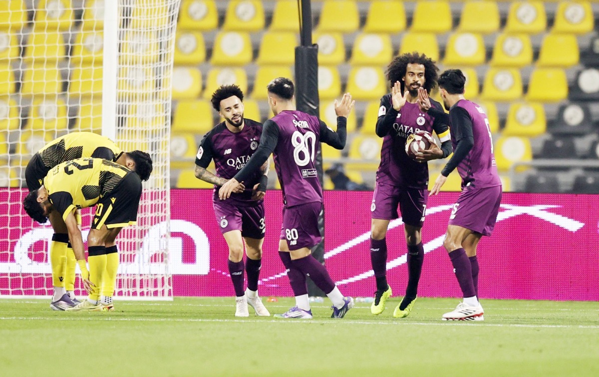 Al Sadd's Akram Afif (second right) celebrates with teammates after scoring a goal.