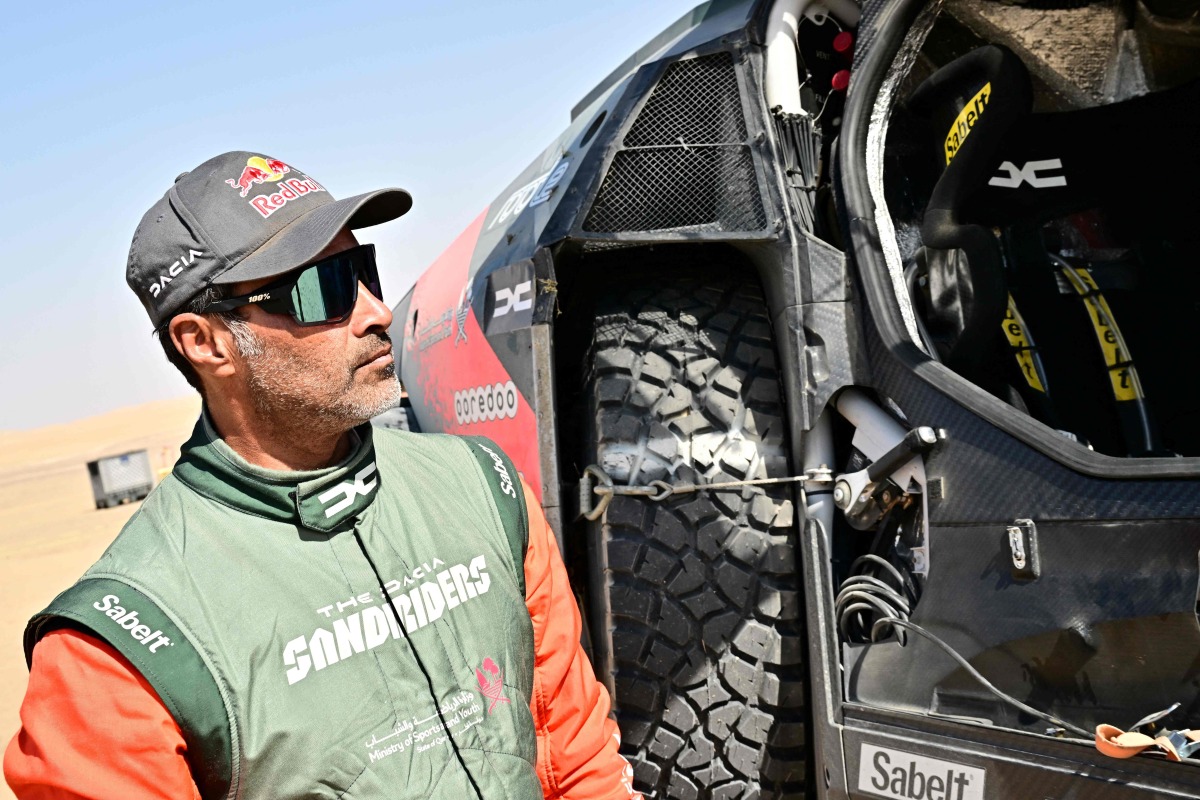 Nasser Al Attiyah stands next to his car after competing in Stage 9. PIC: AFP 