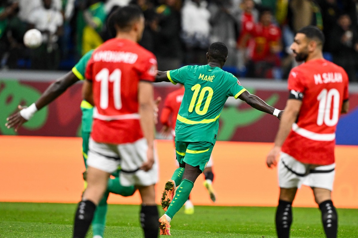 Egypt's forward #10 Mohamed Salah celebrates after the Africa Cup of Nations (CAN) semi-final football match between Senegal and Egypt at the Grand stadium in Tangiers on January 14, 2026. (Photo by SEBASTIEN BOZON / AFP)