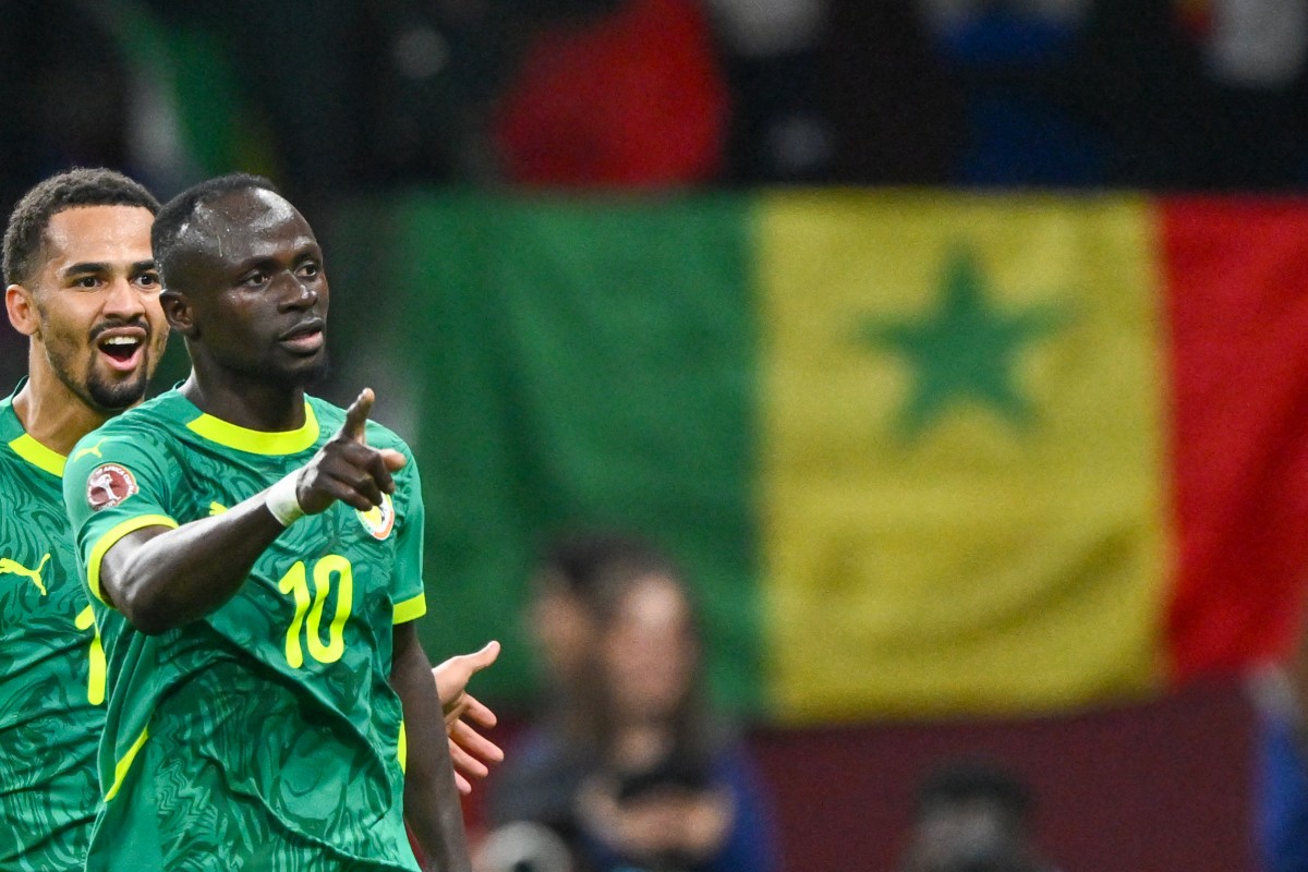 Senegal's forward #10 Sadio Mane celebrates his goal with Senegal's forward #13 Iliman Ndiaye during the Africa Cup of Nations (CAN) semi-final between Senegal and Egypt at the Grand stadium in Tangiers on January 14, 2026. (Photo by Sebastien Bozon / AFP)
