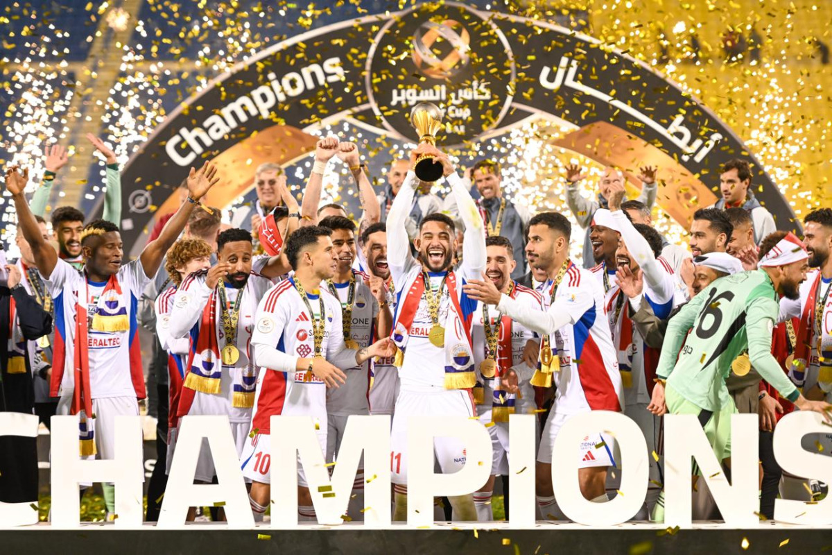 Sharjah players celebrate with the Qatar-UAE Super Cup.  