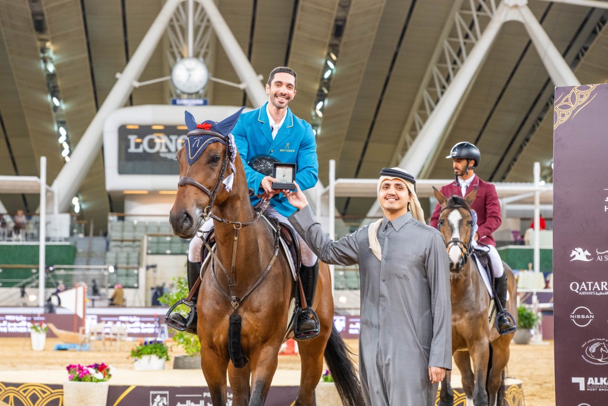 Chairman of the Board of Directors of the Qatar Fund for Development H E Sheikh Thani bin Hamad bin Khalifa Al Thani presents the trophy to Salman Mohammed Al Emadi.