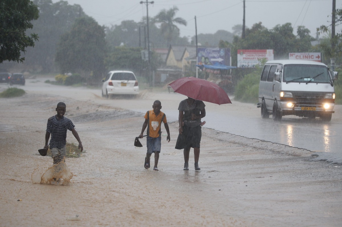 People walk in heavy rain in Harare, Zimbabwe, Jan. 24, 2026. (Str/Xinhua)