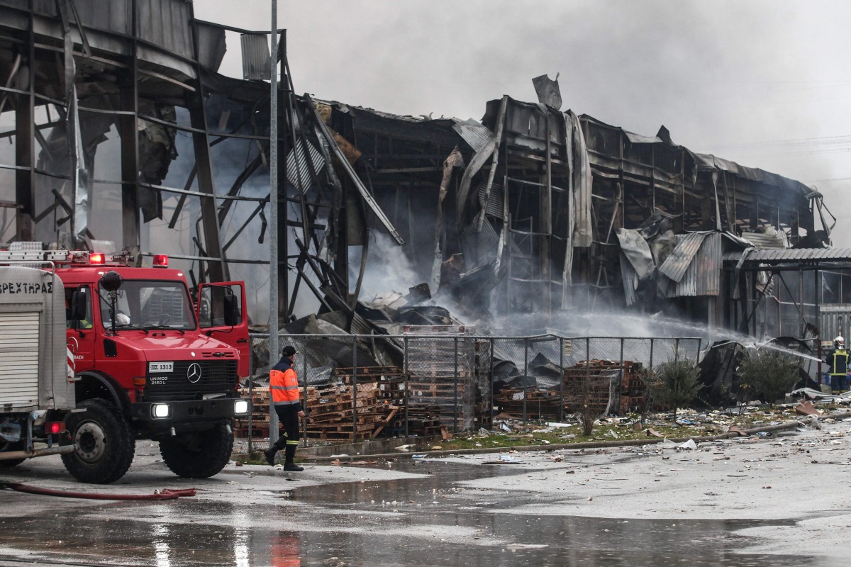 Firefighters try to extinguish a fire at a factory in Trikala on January 26, 2026. Photo by Thanasis KALLIARAS / Eurokinissi / AFP